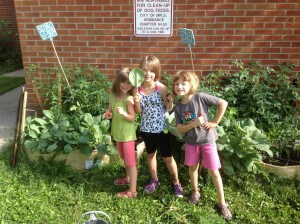 Enthusiastic young gardeners enjoying the fruits of their labor. 