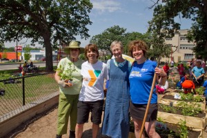 Volunteers from the Twin Cities Corporate Garden Giving Network help plant a community garden at the Midway YMCA in St. Paul.