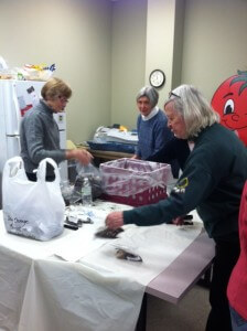 Volunteers packing bulbs for sale at the home shows. 
