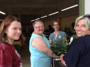 Vicky Vogels (rear) assists Kyra, Linda and Jenny as they register for the plant show. 