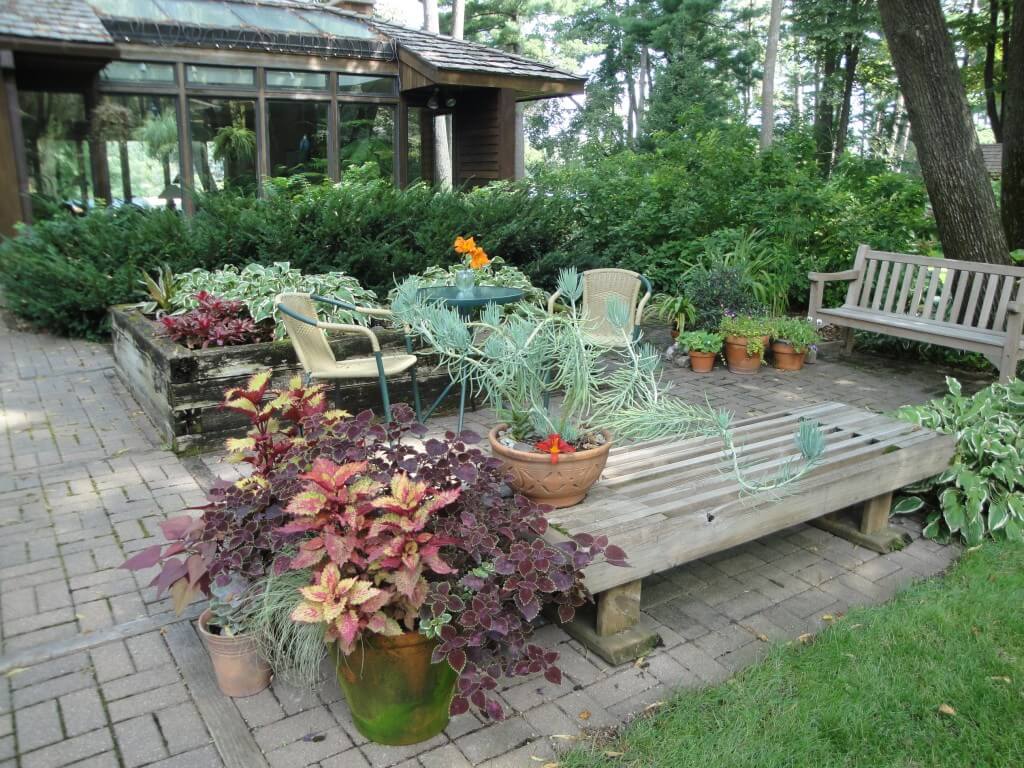 This shady patio is big enough for a table, seating, even some pretty containers. 
