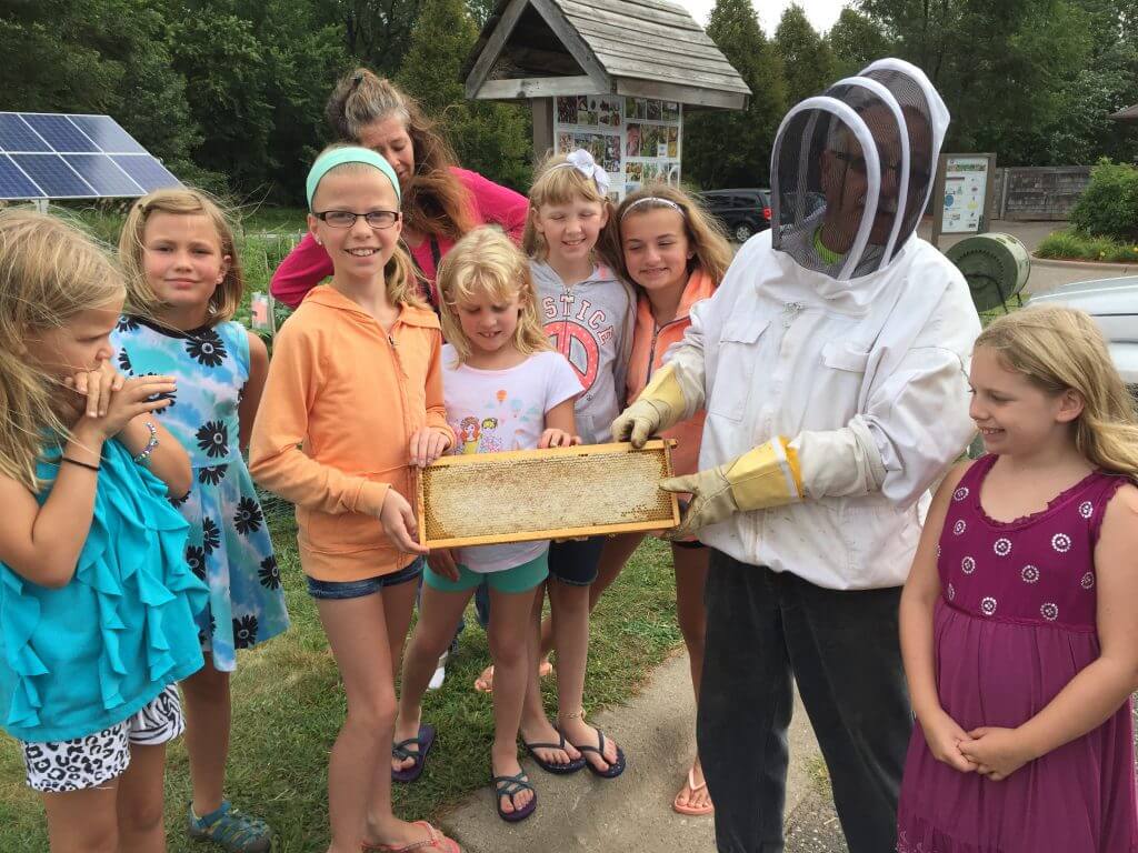 BeekeeperA.J. Moses brings beehives to the garden to teach children about pollinators and honey, which is harvested and donated to the food shelf.