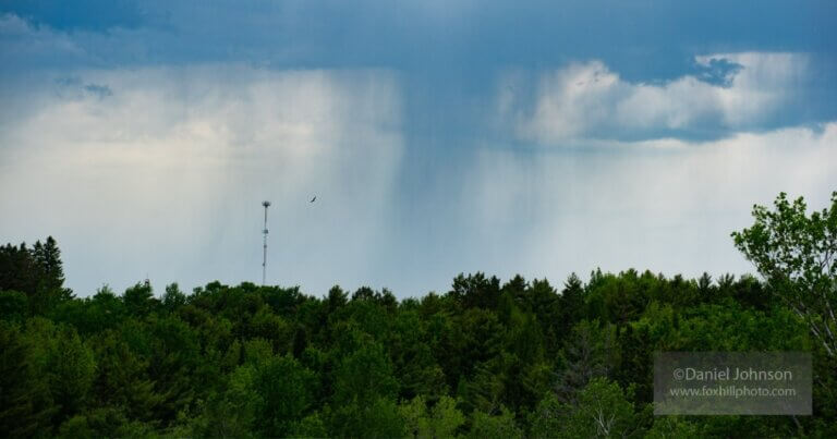 Approaching storm cloud raining