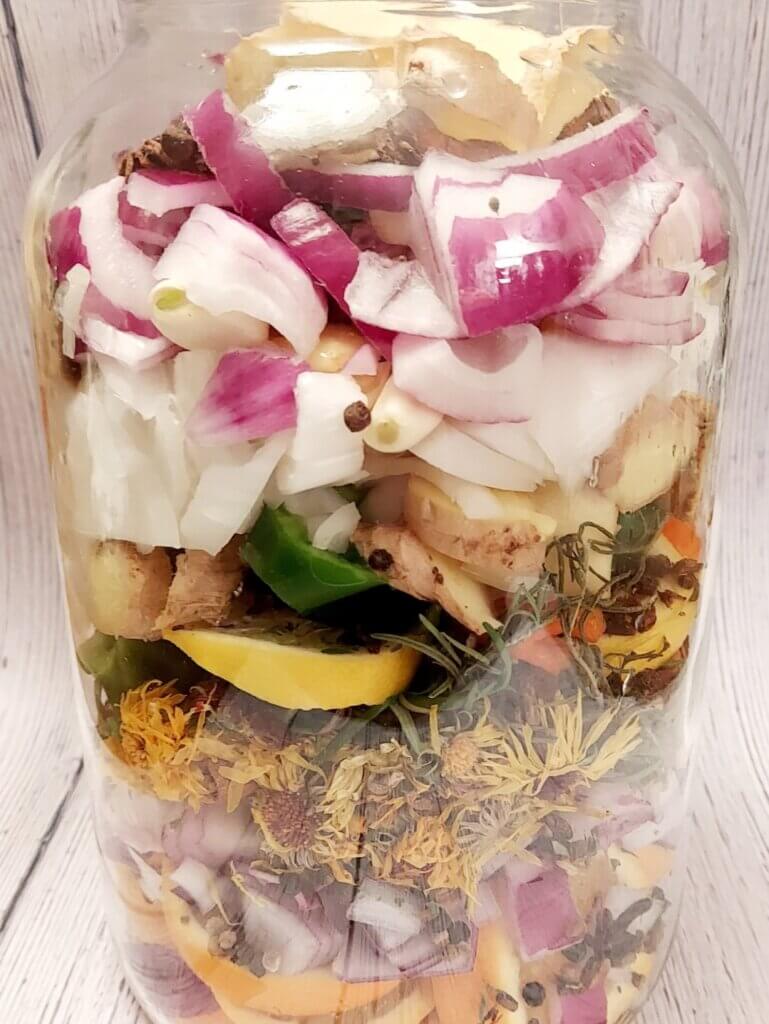 Vegetables chopped and fermenting in a jar