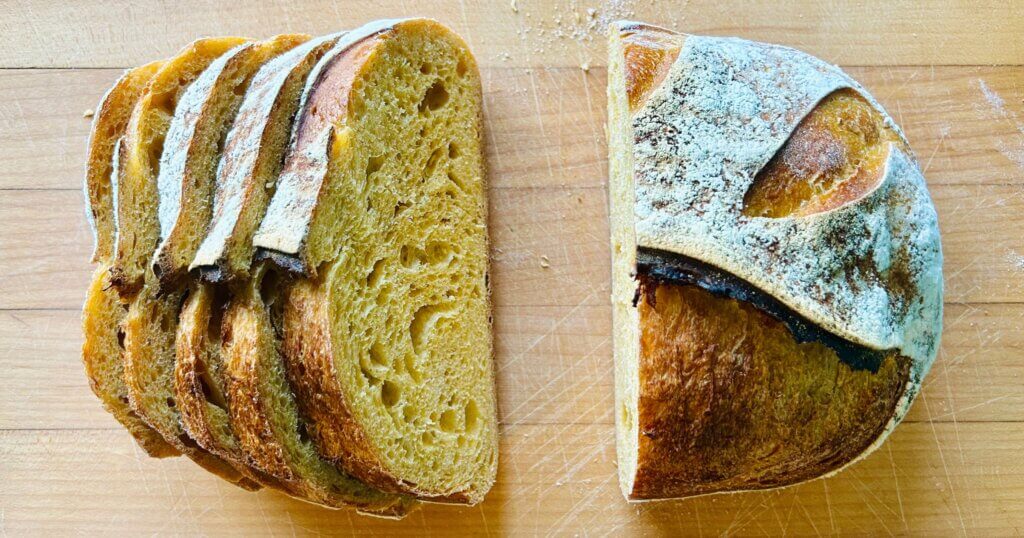 Golden squash sourdough bread cut loaf on a countertop