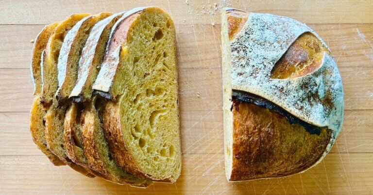 Golden squash sourdough bread cut loaf on a countertop