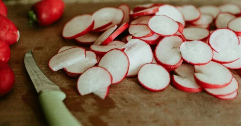 Sliced radishes on a cutting board